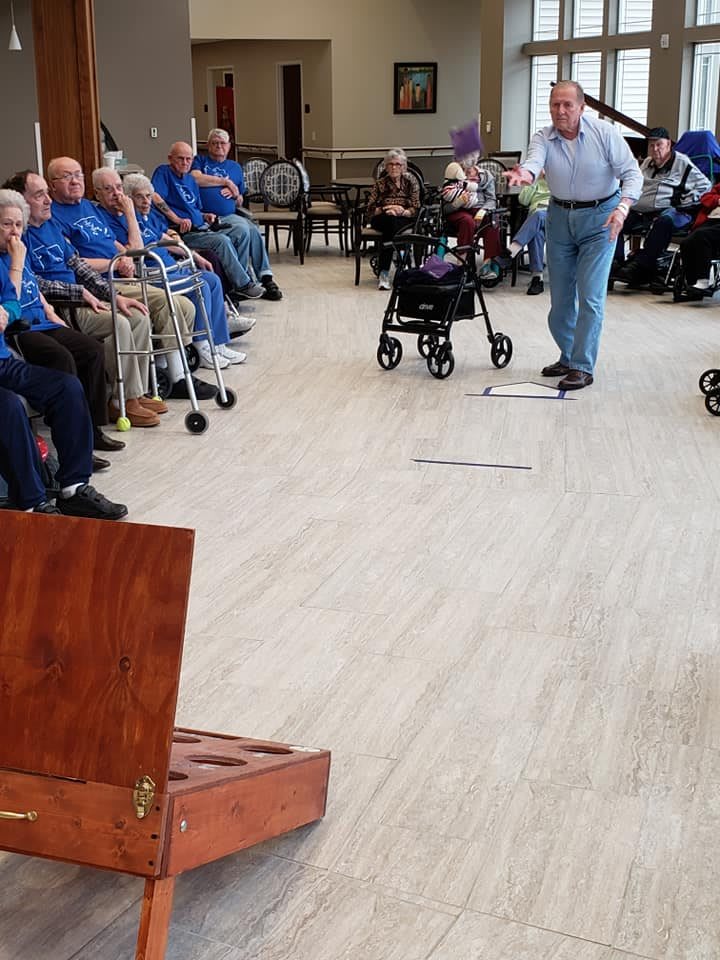 A group of seniors participating in an indoor recreational activity.