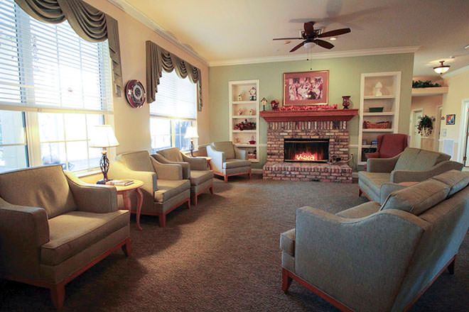 A cozy living room with a fireplace and comfortable seating.