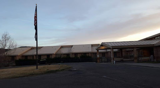 An abandoned building under a cloudy sky.