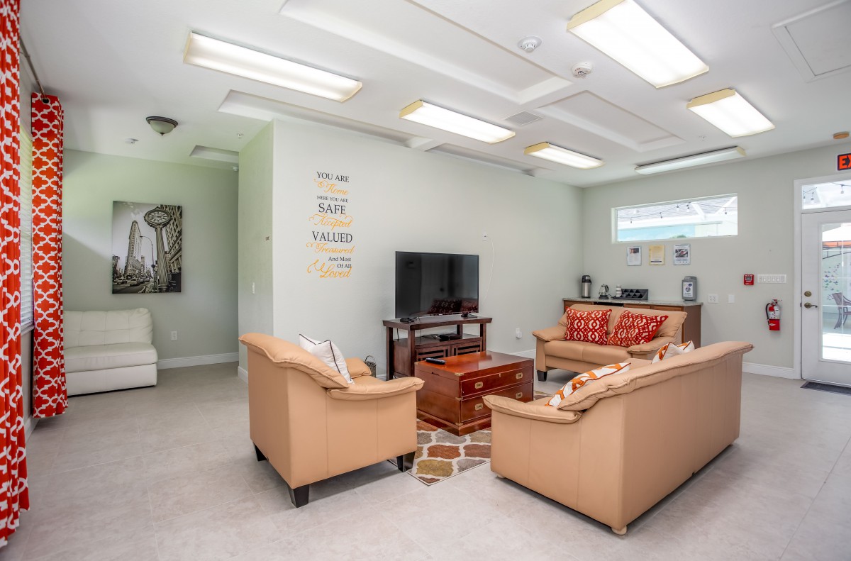 A cozy living room with sofas, a television, and a coffee table.