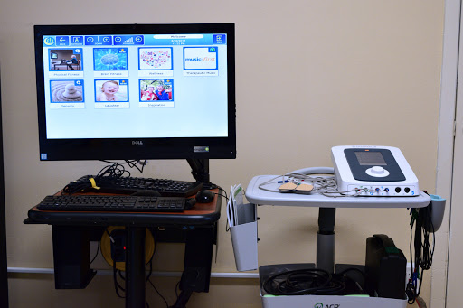 A medical setup featuring a monitor displaying various images alongside an ultrasound machine.