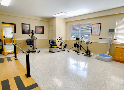 A well-equipped fitness and rehabilitation room with various exercise machines.