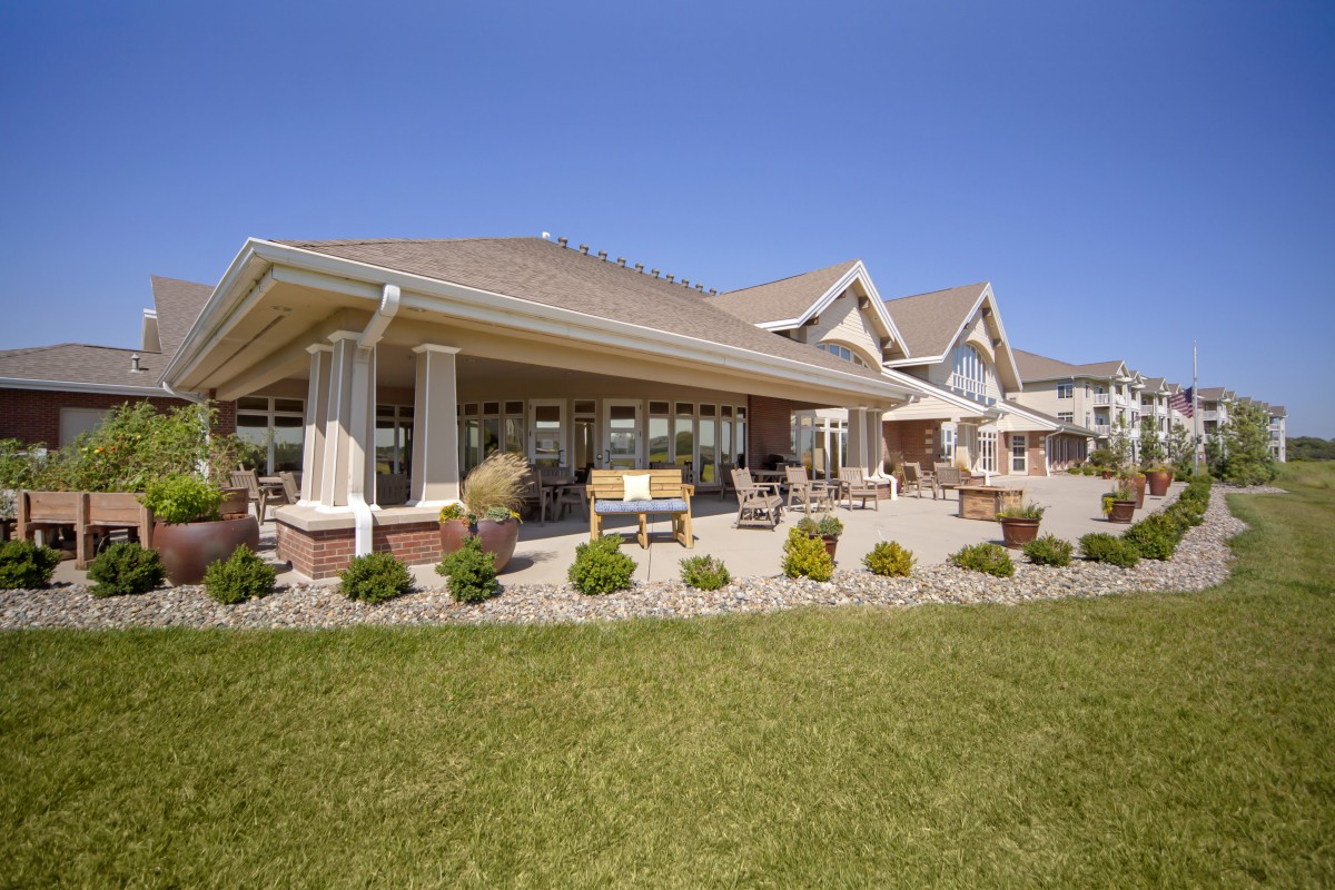 A modern house with a well-maintained lawn and outdoor patio area.