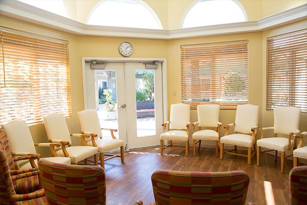 A bright waiting room with arranged chairs and sunlight streaming through the windows.