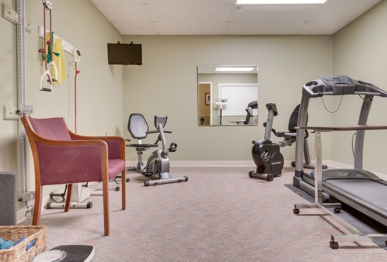 A small exercise room equipped with stationary bikes and an elliptical machine.