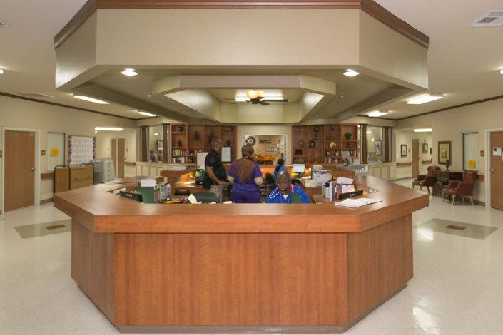 A hospital reception area with medical staff seated at the desk.