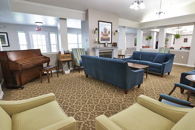 A cozy lobby area with comfortable seating and a piano.
