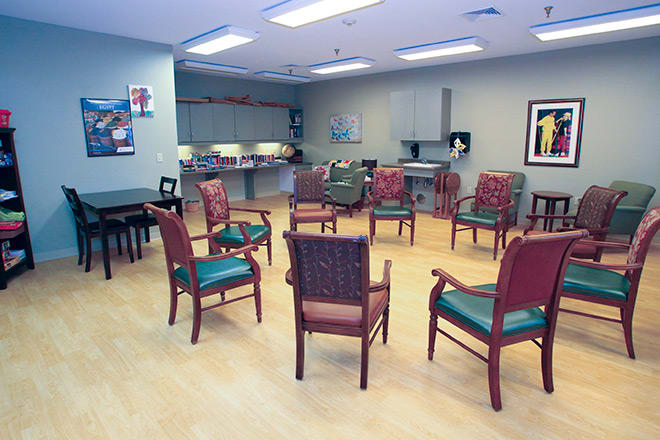 A community meeting room arranged with chairs in a circle.