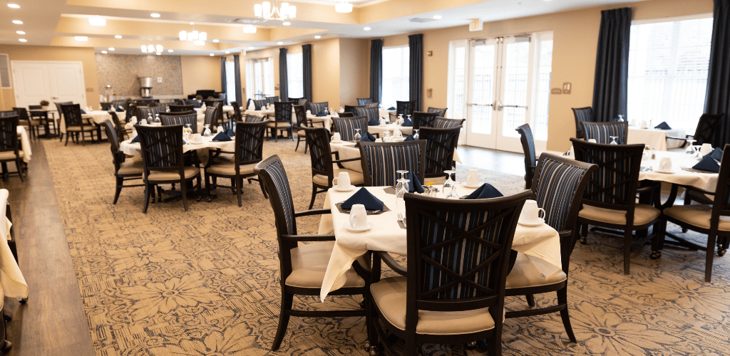 An elegant dining room with neatly arranged tables and chairs, ready for guests.