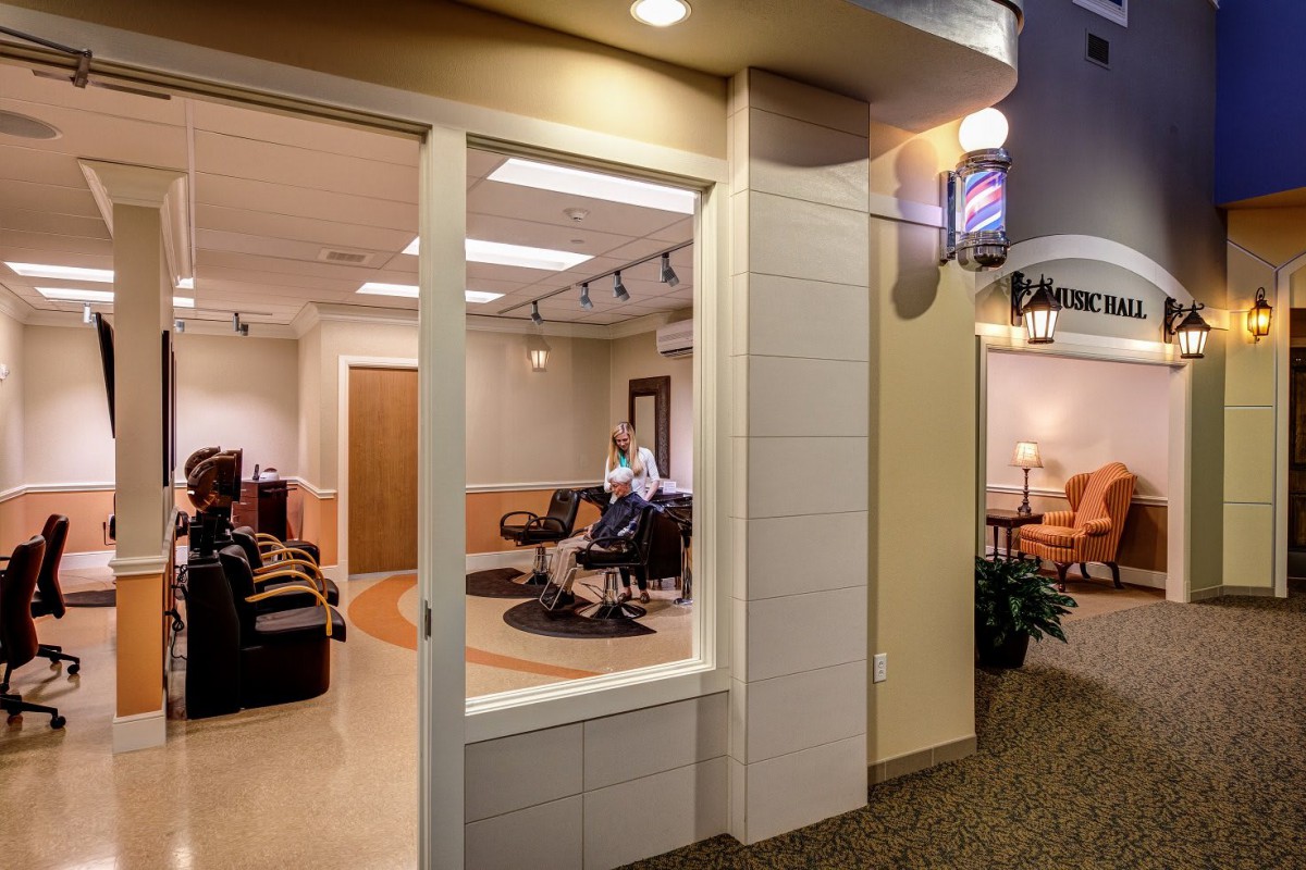 A modern hair salon interior with styling stations and a cozy waiting area.