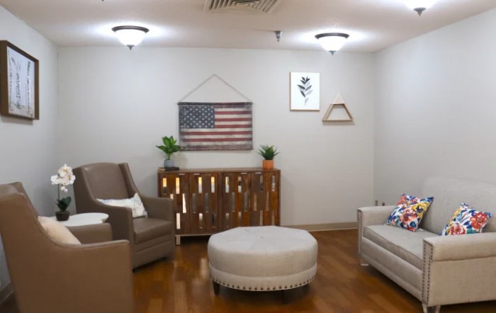 A cozy living room with comfortable seating and American-themed decor.