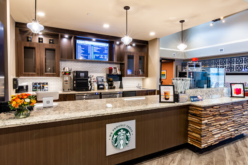 A modern Starbucks coffee shop interior featuring a sleek counter and barista equipment.