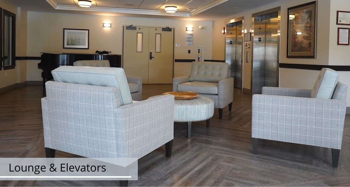 A modern lobby seating area with comfortable chairs and neutral decor.