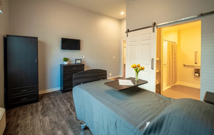 A modern spa room featuring a massage table, soft lighting, and a calming atmosphere.