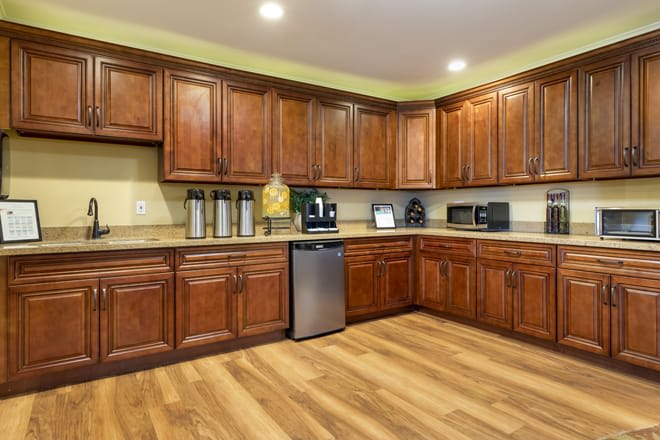 A modern kitchen with wooden cabinets and stainless steel appliances.