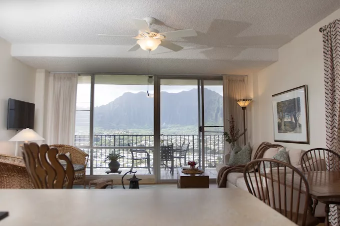 A cozy living room with a stunning mountain view from the balcony.