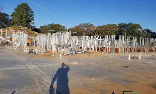 A construction site with metal frames and a clear blue sky, showcasing the early stages of building development.