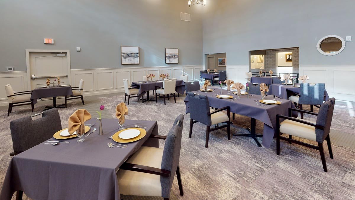 A neatly arranged dining area with tables set for guests.