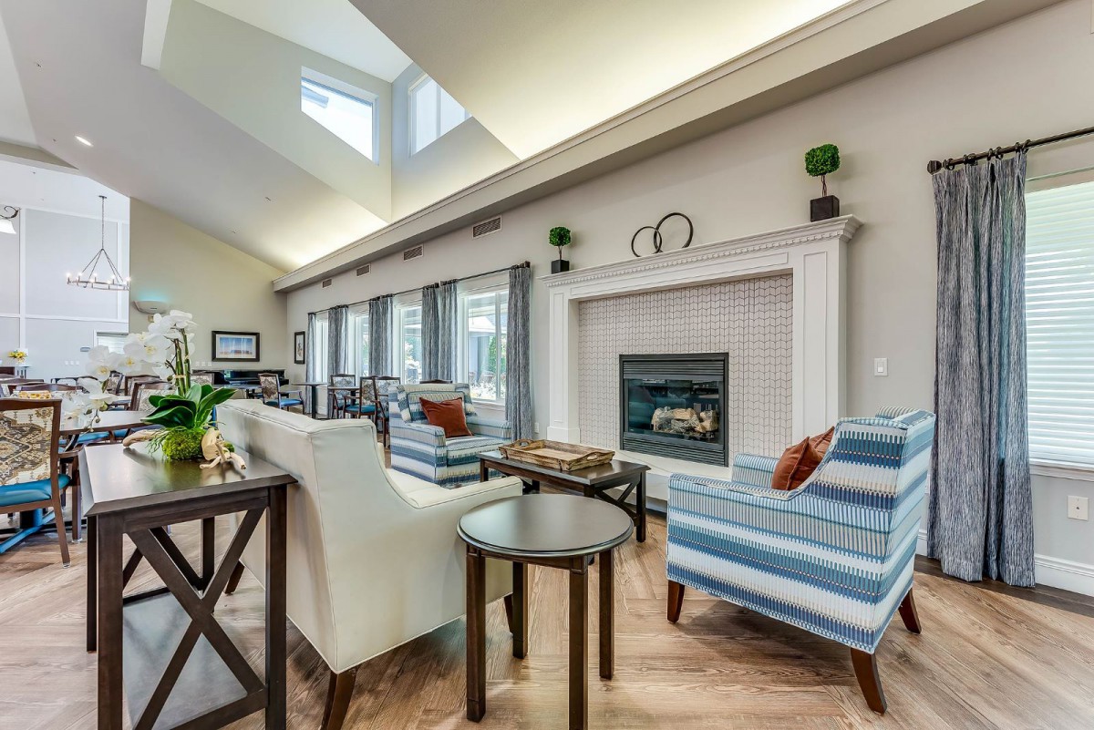 A modern living room with a fireplace and stylish furniture.