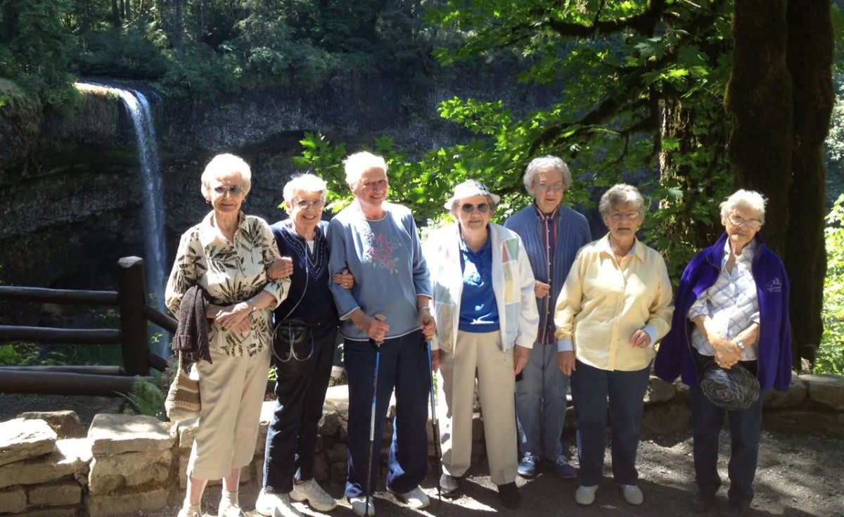 A group of seniors enjoying a sunny day together outdoors.
