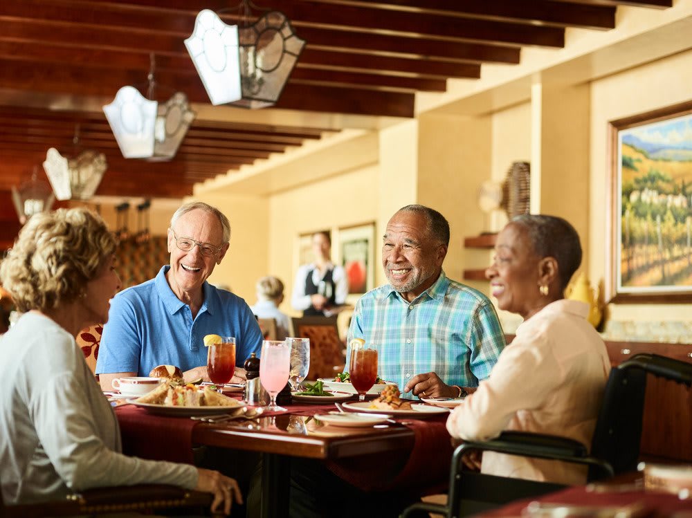 A group of people enjoying a meal together in a restaurant.