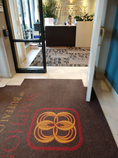 The welcoming entrance of a hotel lobby, featuring a decorative mat and reception area.