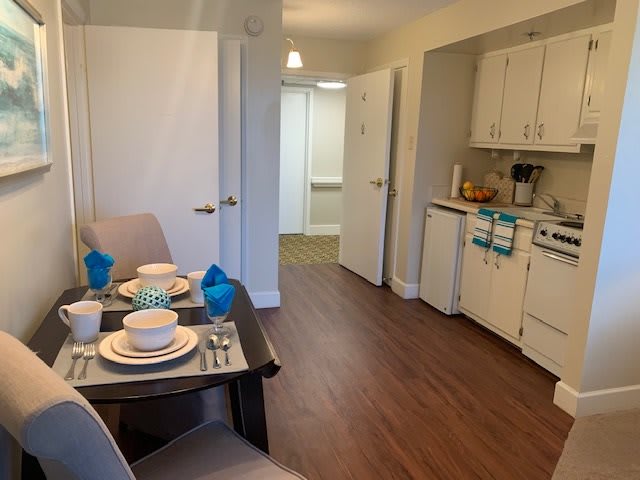 A cozy apartment kitchen and dining area with a neatly set table.