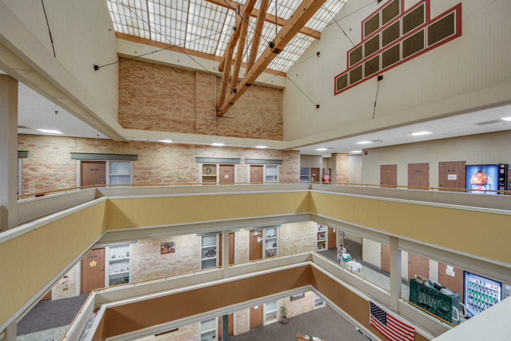 A modern atrium with multiple levels and a large skylight.