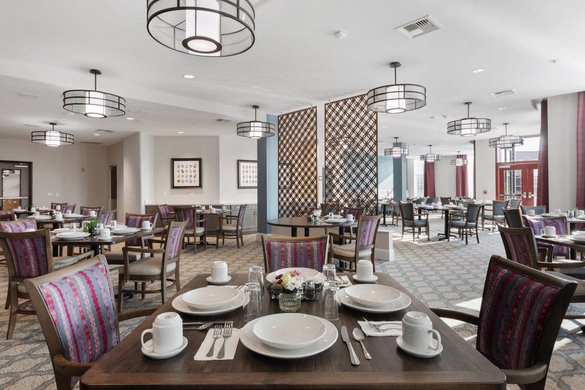 A modern restaurant dining area with neatly set tables and contemporary decor.