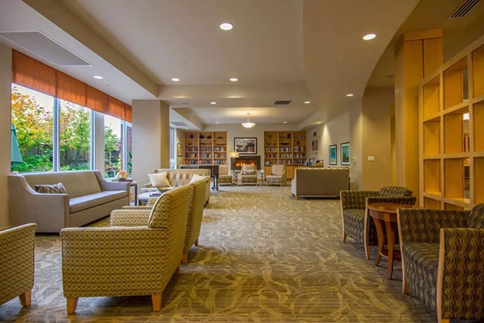A spacious and cozy living room with modern decor, featuring ample seating and a warm ambiance.
