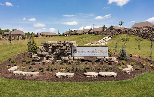 Entrance view showcasing the beautifully landscaped grounds and welcoming sign.