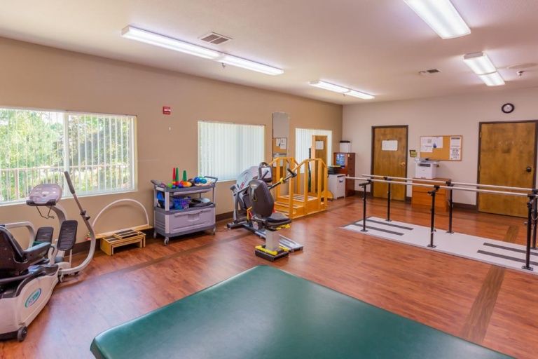 A well-equipped physical therapy room with various exercise machines and tools.