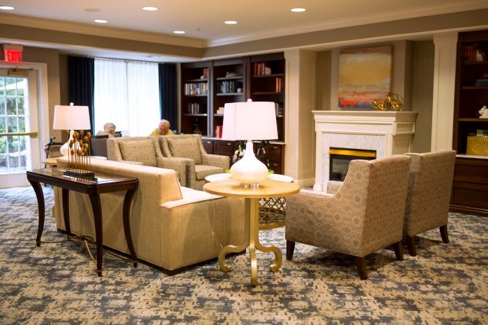 Cozy living room with comfortable seating, ambient lighting, and a fireplace.