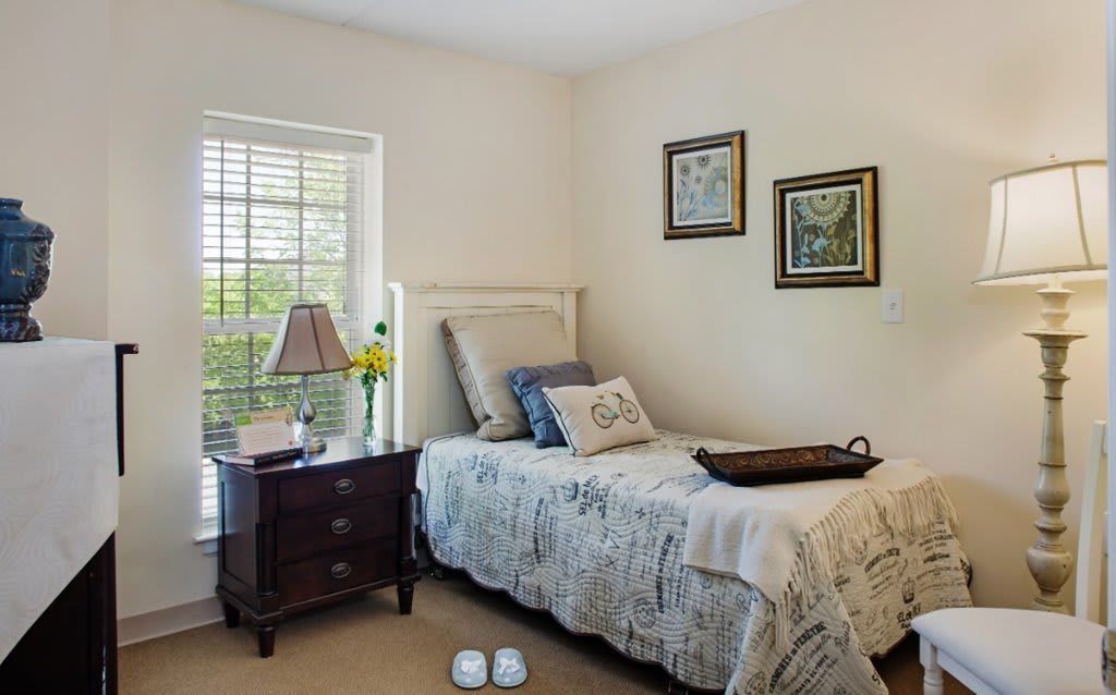 A cozy bedroom with a single bed and stylish decor.