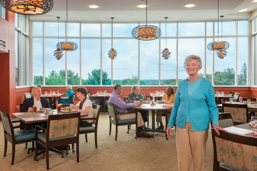 A lively dining area with patrons enjoying their meals in a bright and welcoming atmosphere.