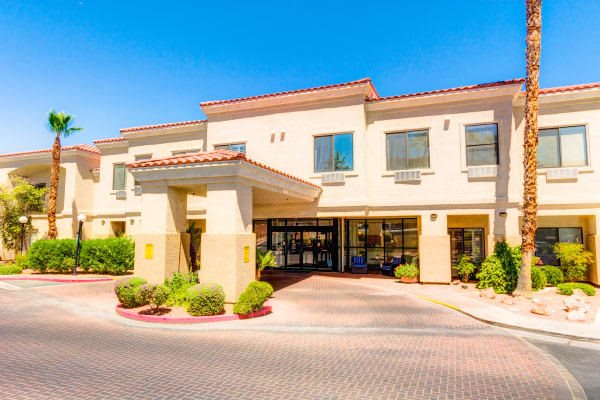 A sunny day view of a hotel exterior with a welcoming entrance.