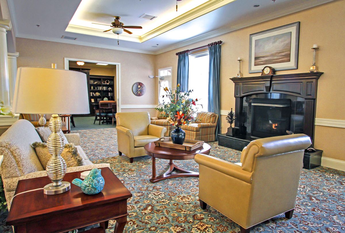 A cozy living room with comfortable seating, a fireplace, and tasteful decor.