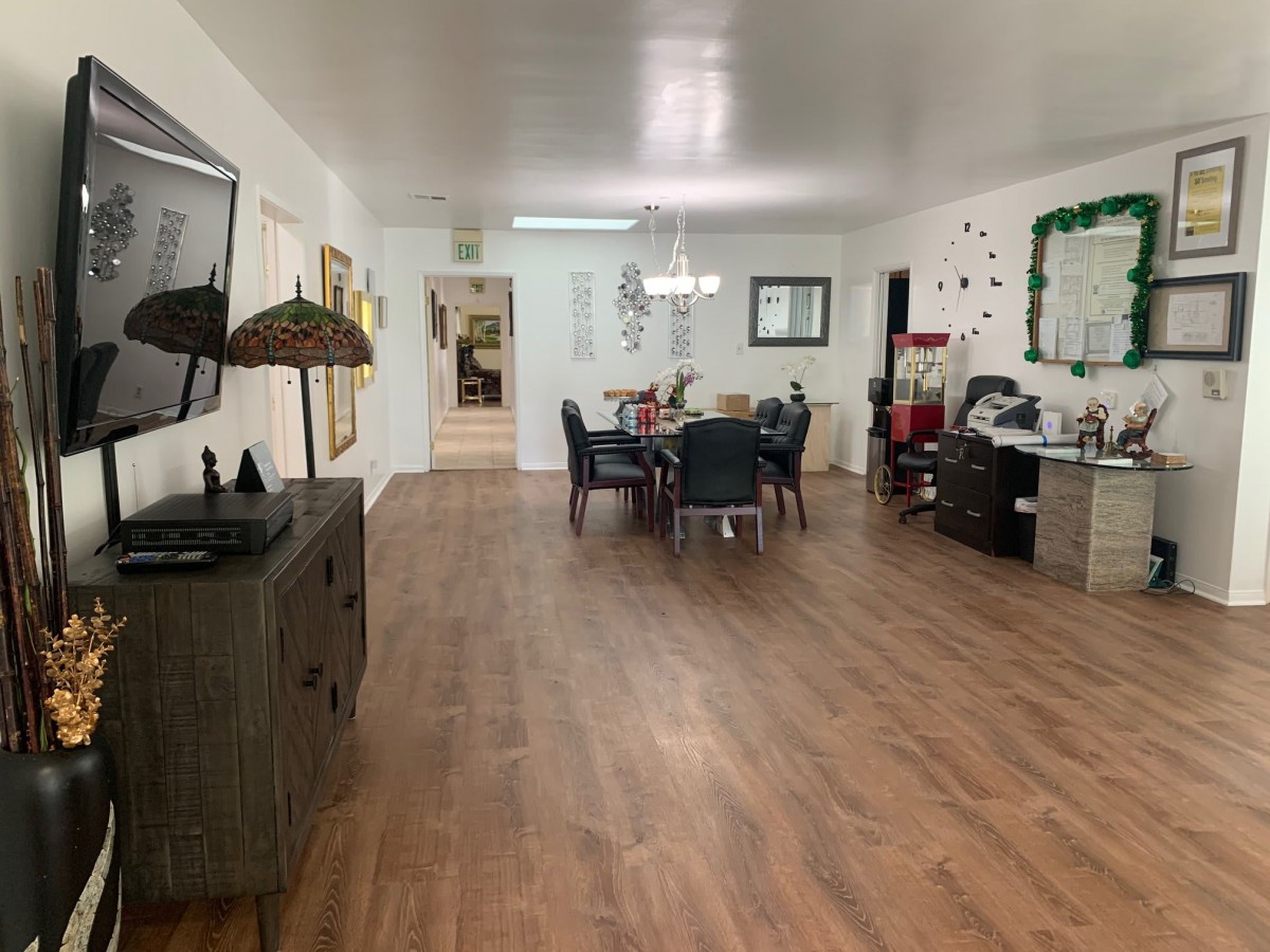 Spacious dining room with wooden floors and modern decor.