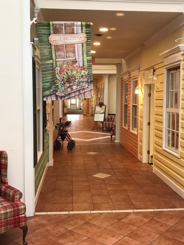 A decorative indoor hallway designed to resemble a charming street with storefronts and benches.