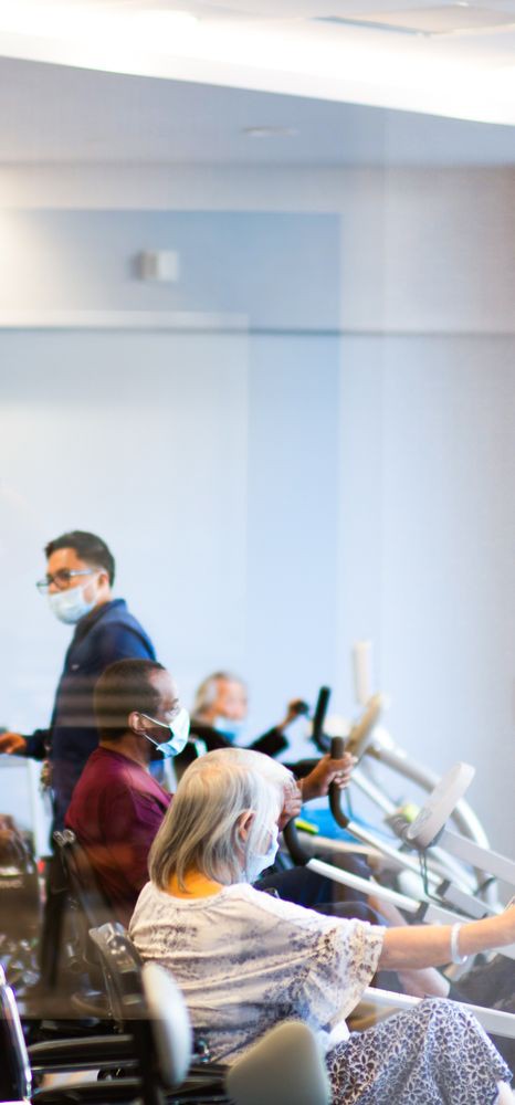 A group of people wearing masks in an indoor meeting setting.