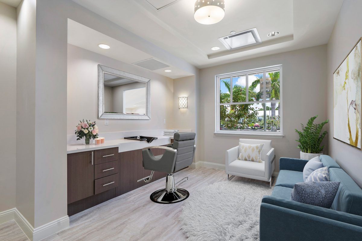A modern, bright office space with comfortable seating and a large window overlooking greenery.