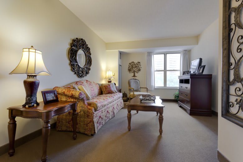 A cozy living room with a patterned sofa, coffee table, and decorative elements.