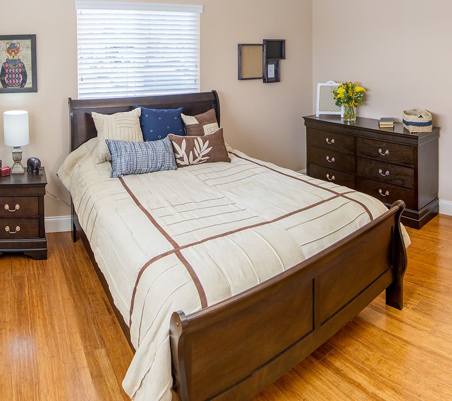 A cozy bedroom with a neatly made bed and stylish decor.