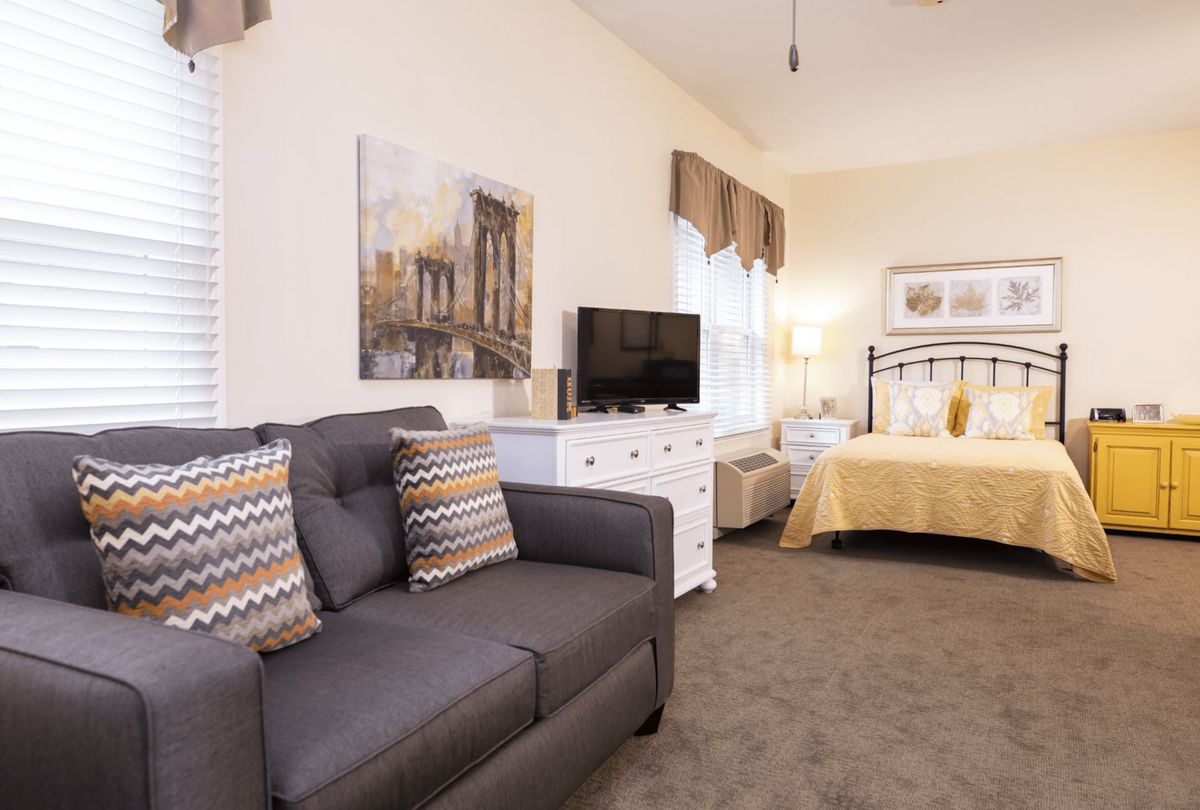 A cozy bedroom with a comfortable sofa and stylish decor.