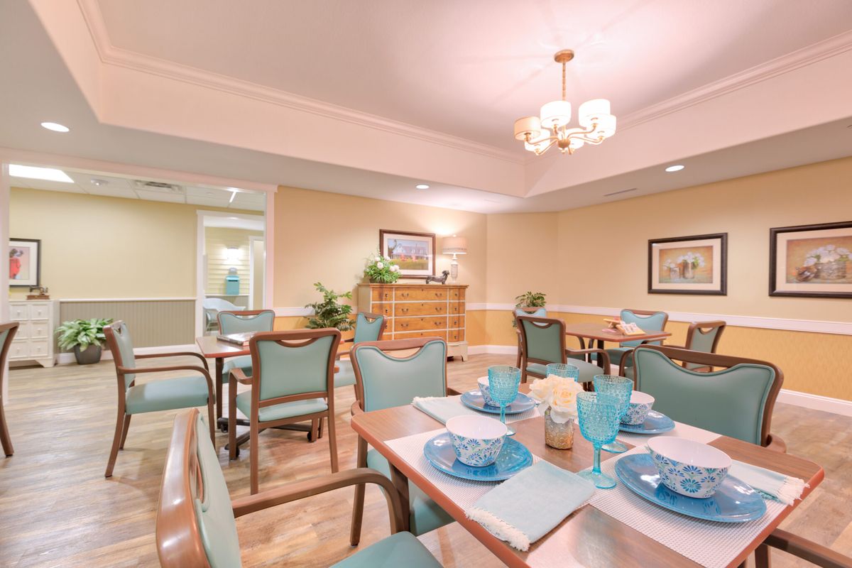 A well-arranged dining room with neatly set tables and elegant decor.