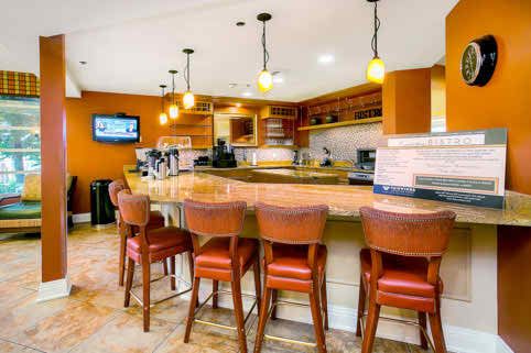 A cozy bar area with leather chairs and warm lighting.