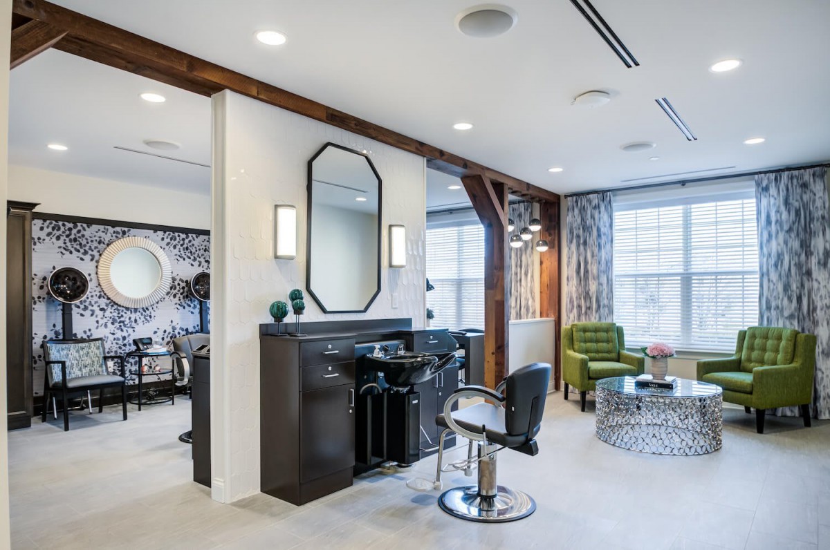 Modern salon interior with stylish furniture and bright lighting.