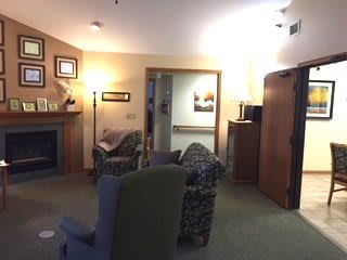 A cozy living room with comfortable seating and a warm fireplace.