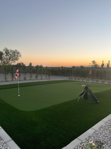 A serene putting green at sunset, perfect for practicing golf.