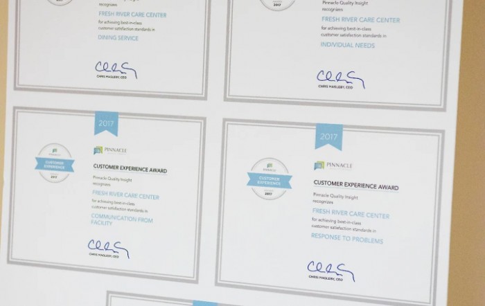 A collection of framed certificates showcasing educational achievements and recognitions.